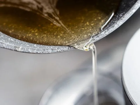 Used cooking oil draining from a commercial fryer into a collection tray in a Sydney kitchen