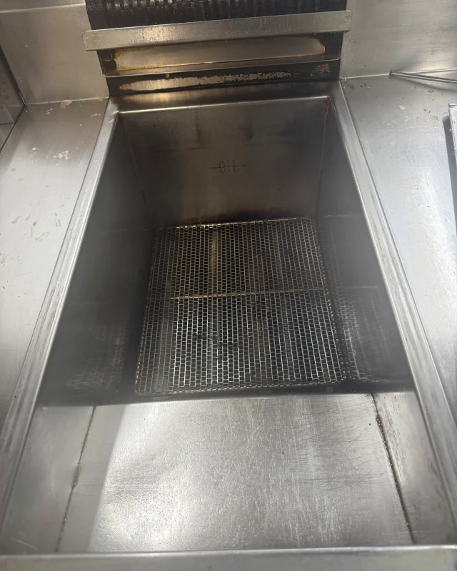 The same fryer vat boiled out to bare stainless steel with its crumb screen refitted