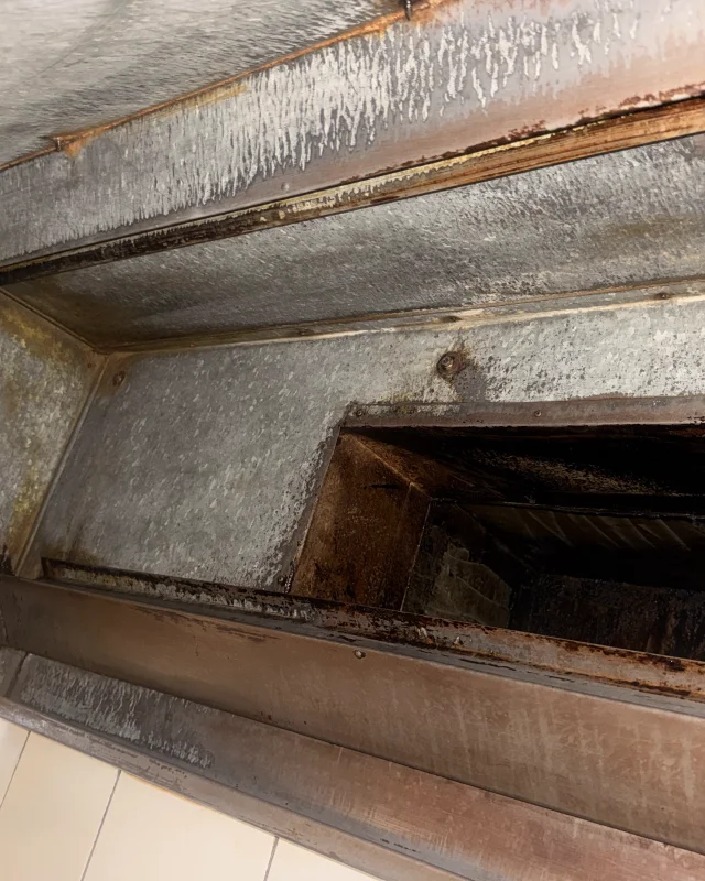 The same gutter and duct collar stripped back to bare galvanised metal after degreasing