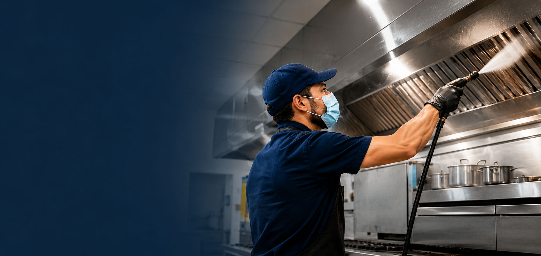 HygieneXperts technician pressure-cleaning a commercial kitchen exhaust canopy in Sydney