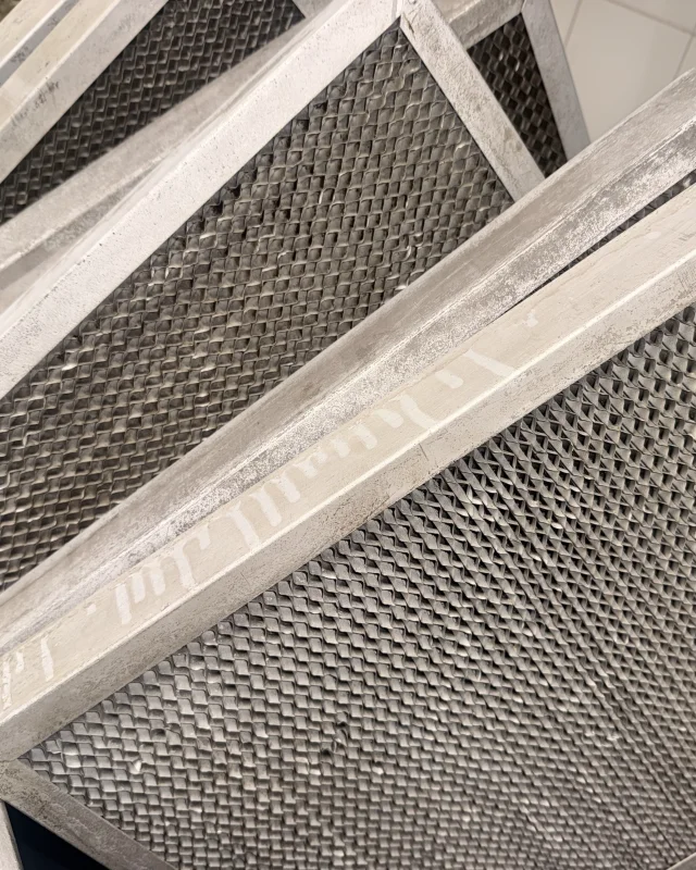 The same honeycomb mesh filters back to bare aluminium after degreasing