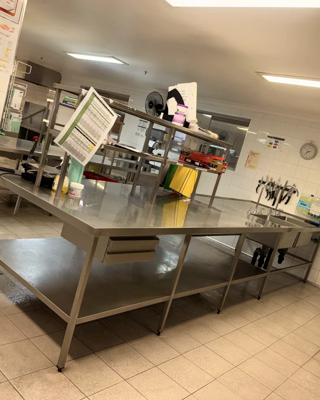 Commercial kitchen prep bench, undershelf and sink polished back to bright stainless steel after deep cleaning